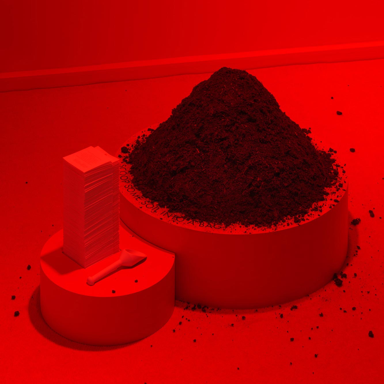 red sculpture with soil